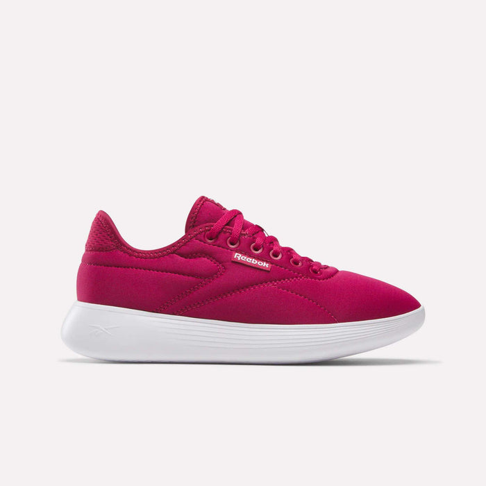 The Reebok Women's Active Lite Shoes are shown in bright pink with DMX technology, a mesh upper, white sole, and laces. Displayed in side profile against a plain light background.