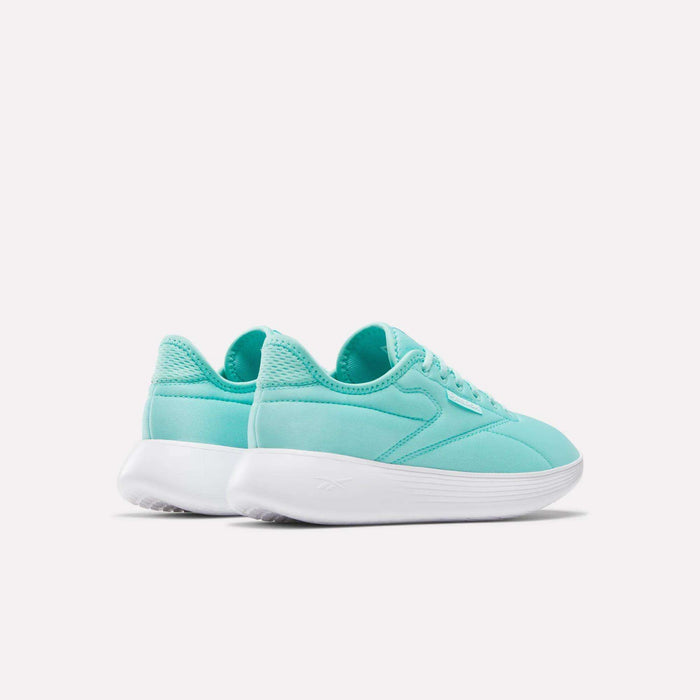 A pair of Women's Active Lite Shoes by Reebok in teal with white soles, featuring DMX technology, are placed side by side on a white background, angled to display the backs and outer sides.
