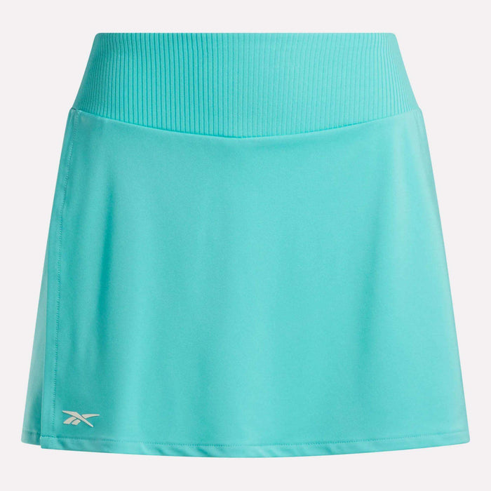 The Women's Athlete Speed Skort 3" by Reebok is turquoise, features a ribbed waistband, built-in shorts, and a small white Reebok logo near the left hem.