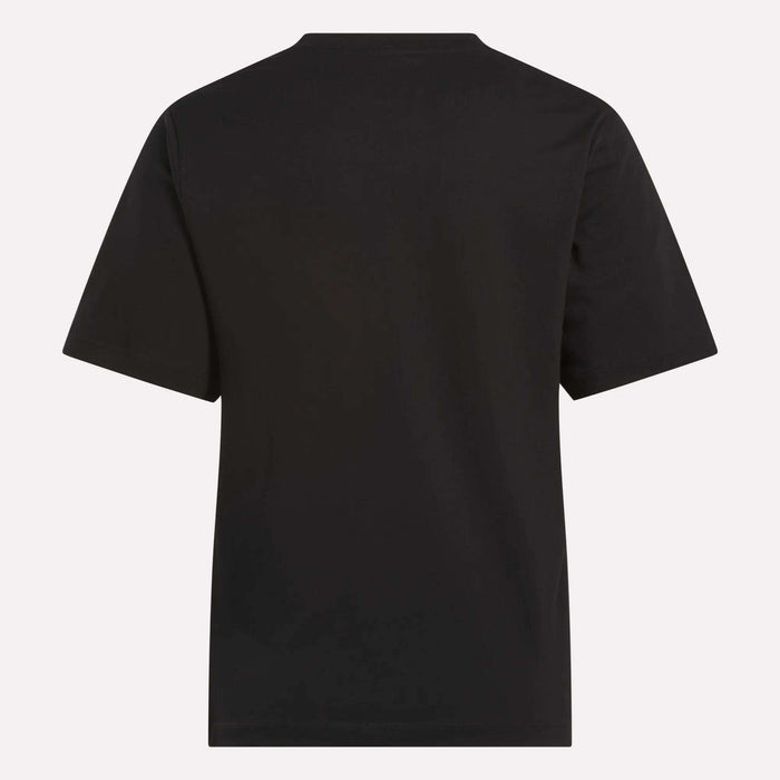 The Reebok Women's Big Logo Crewneck Short Sleeve Tee is shown from the back against a light background. This plain black cotton jersey t-shirt features no visible logos, patterns, or extra design elements.