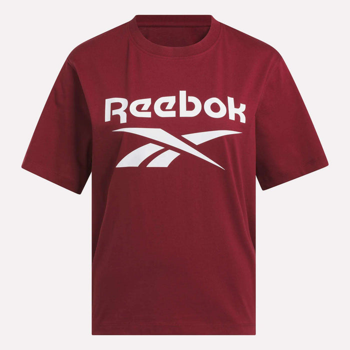 The Women's Big Logo Oversized Crew Short Sleeve Tee by Reebok features a maroon color, white Reebok logo and name across the chest, short sleeves, a classic neckline, and an oversized fit for comfort.