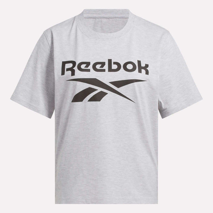 The Reebok Women's Big Logo Oversized Crew Short Sleeve Tee is a light gray shirt with a bold black Reebok logo across the chest, designed in an oversized fit for casual comfort.