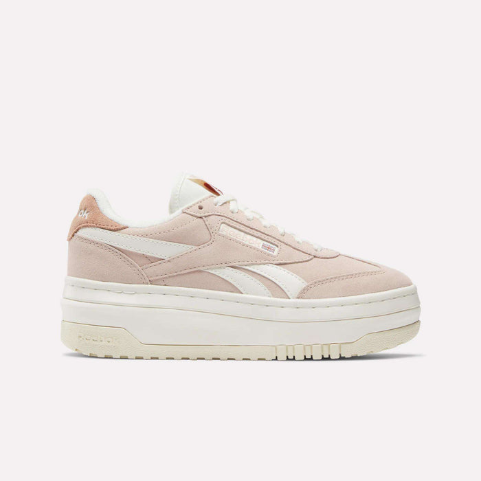 The Women's Campio Extra Shoes by Reebok feature a light pink chunky design with white accents, suede platform details, white laces, and a thick sole. The Reebok logo is visible on the side and heel against a plain white background.