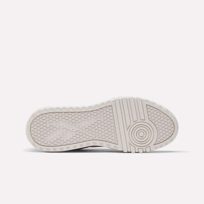 The image displays the bottom view of the Reebok Women's Campio Extra Shoes, highlighting a white platform sole with a textured tread featuring diamond shapes on the left and circular patterns on the right for enhanced grip and traction.