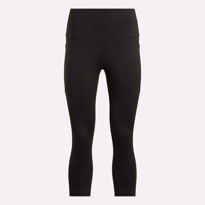 Women's Capri Leggings by Reebok in black, featuring a high waist, ankle length, side pockets, and an adjustable waistband. Shown on a plain white background.