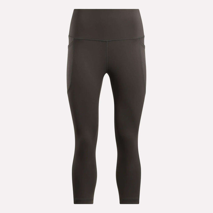 Reebok Women's Capri Leggings in black, shown on a plain light background. These fitted, high-waisted leggings offer a smooth finish, subtle seam details, and ankle-length style—ideal for any fitness routine.