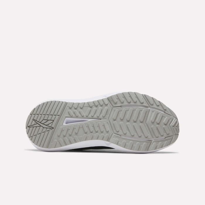 The image displays the gray rubber outsole of Reebok Women's Cityride 2 Running Shoes, featuring a textured tread with zigzag and straight grooves for traction. A Reebok logo appears on the left side. The background is plain white.