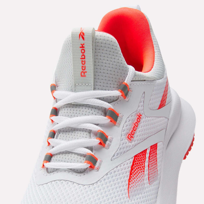A close-up of the Reebok Women's Cityride 2 Running Shoes in white with orange accents, mesh upper, white laces with orange eyelets, Reebok logo on tongue and side, and plush FuelFoam cushioning for comfort.