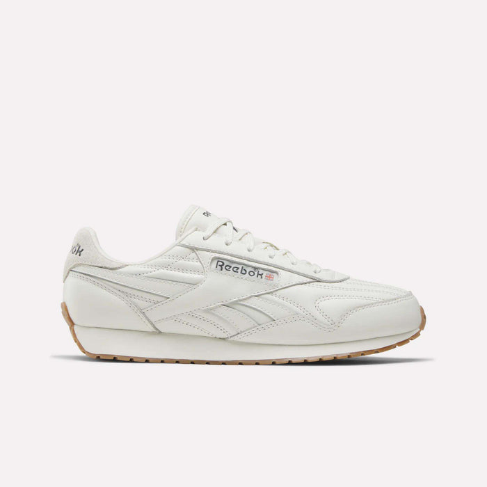 A Reebok Women's Classic AZ Shoe in Chalk/Chalk/Gum features a leather upper, gum sole, side branding, and stitched details—shown from a side view against a plain light background—capturing the enduring style of Reebok women's footwear.