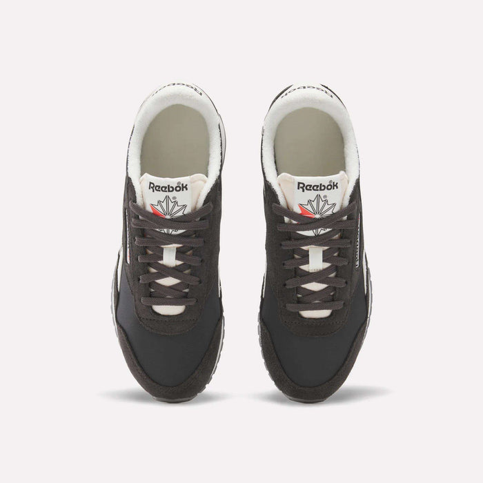 A pair of Women's Classic AZ Shoes by Reebok in black, featuring white soles and laces, are shown from above on a plain white background. The Reebok logo and a red and gray star appear on the tongues.