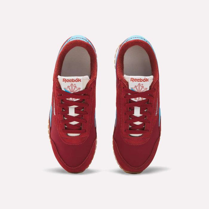Top view of Reebok Women's Classic AZ Shoes in red with white laces, blue accents, and brown soles, side by side on a white background. The Reebok logo appears on the tongue, emphasizing their classic running-inspired style.