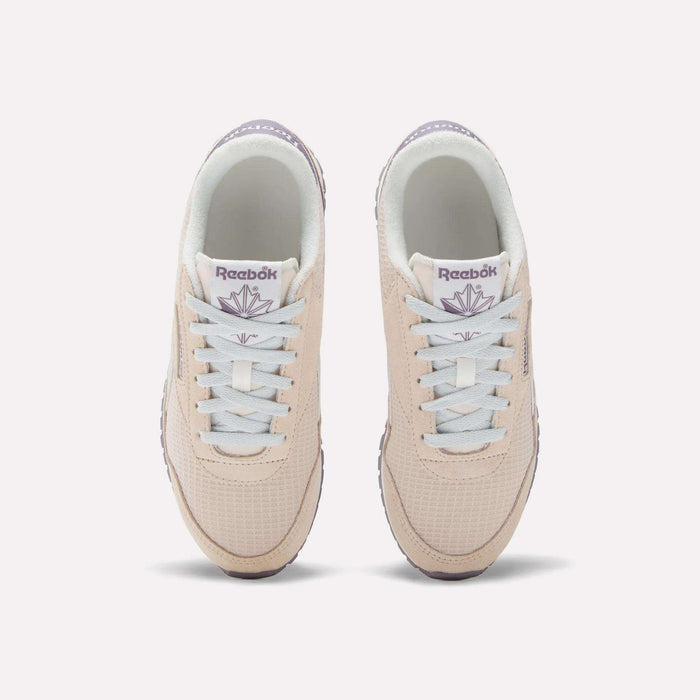 The Women's Classic AZ Shoes by Reebok are beige with white laces and light purple branding, shown from above on a white background—ideal for fans of 70s-style sneakers.