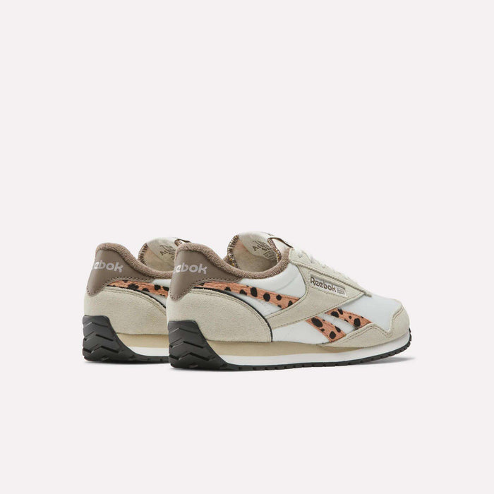 The Reebok Women's Classic AZ Shoes feature beige suede, white leather accents, a cheetah print design on the side, black soles, and Reebok branding on the heel and side.