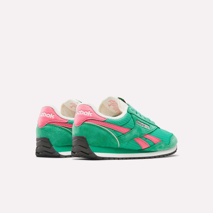 The Reebok Women's Classic AZ Shoes feature a green design with pink and white accents, black soles, and Reebok logos on the side and heel. Displayed on a plain white background, these retro sneakers are inspired by '70s running shoes.