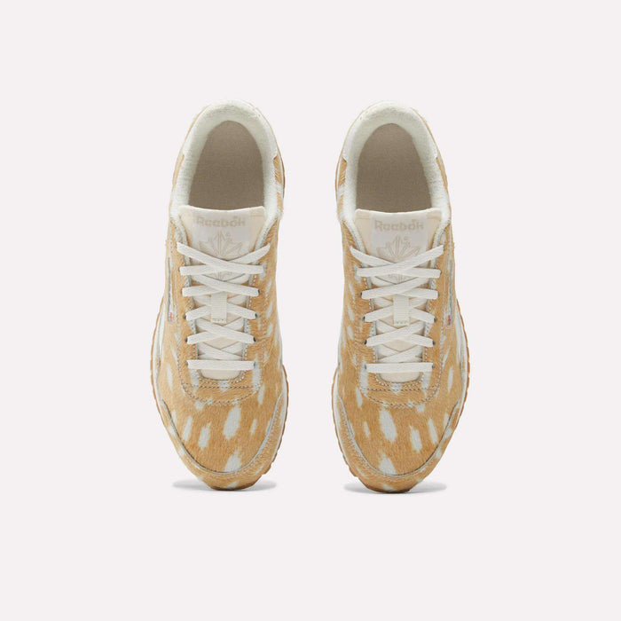 Top view of Reebok Women's Classic AZ Shoes shows beige and white spotted uppers, white laces, and beige midsoles—these vintage-inspired sneakers are placed side by side on a plain light background.