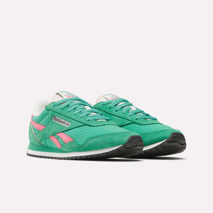 The Reebok Women's Classic AZ Shoes feature a green design with pink accents, white laces, and black soles, evoking retro running style. Product is displayed on a plain white background.