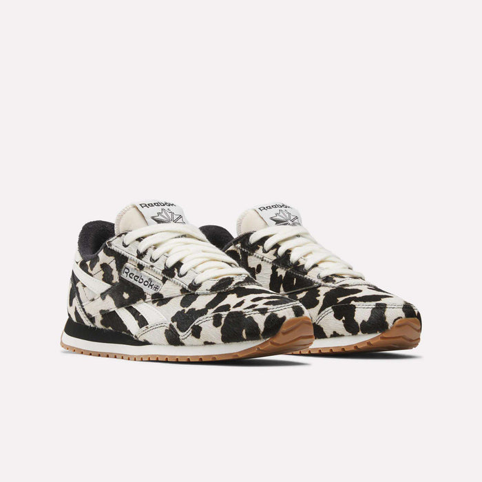 Reebok Women's Classic AZ Shoes feature bold black and white animal print, gum soles, and black accents on a light background.