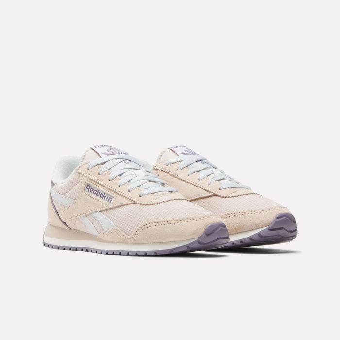 The Women's Classic AZ Shoes by Reebok are beige with white accents, a light purple outsole, and classic branding on the side and tongue, shown against a white background.