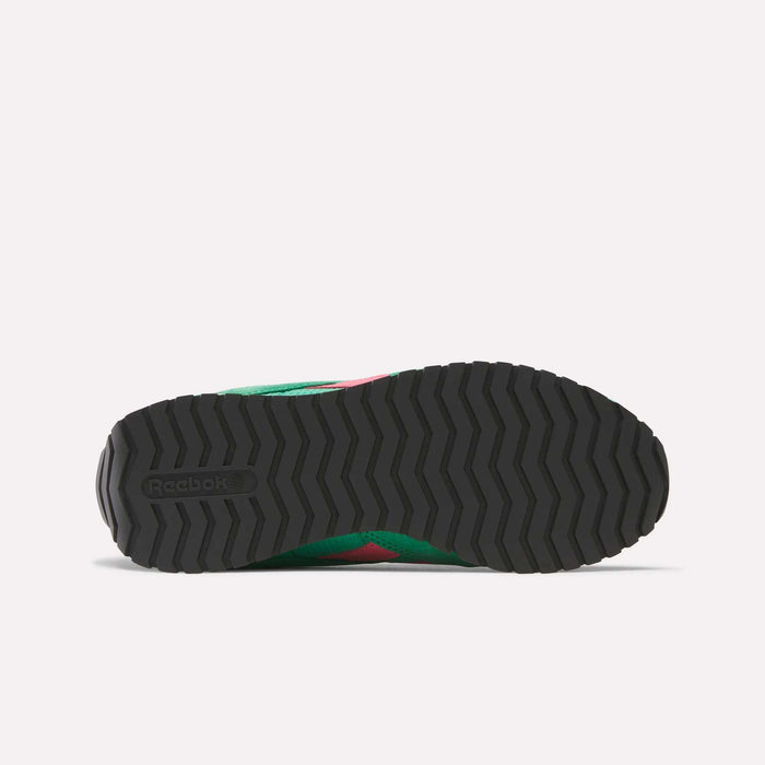 Bottom view of Reebok Women's Classic AZ Shoes featuring a black rubber outsole with a zigzag tread and Reebok logo. The green and pink midsole and upper of this retro running shoe are partially visible.