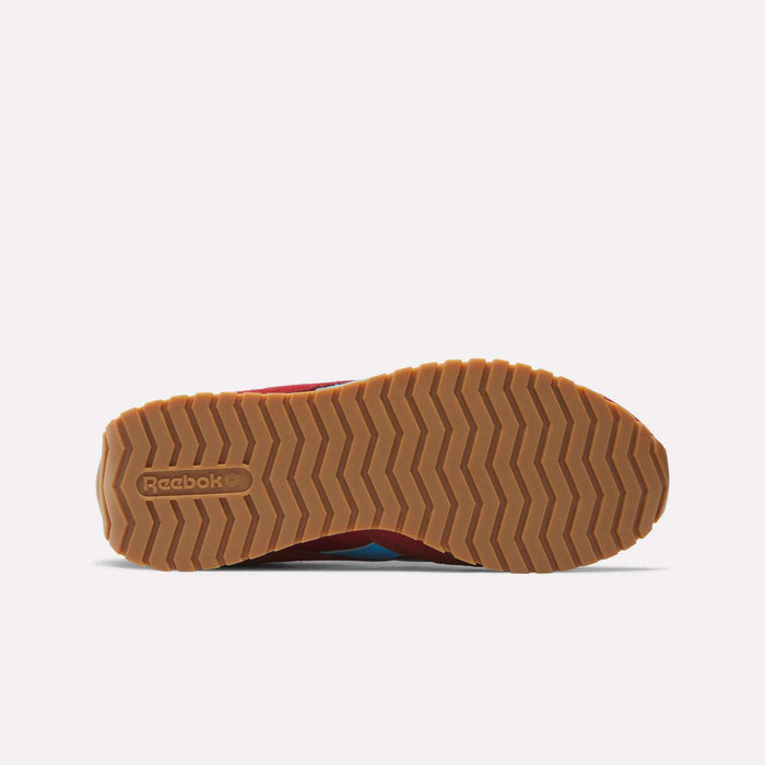 Bottom view of the Reebok Women's Classic AZ Shoes displays a tan rubber sole with a zigzag tread pattern and the embossed Reebok logo near the heel, reflecting the timeless look of vintage women's sneakers.