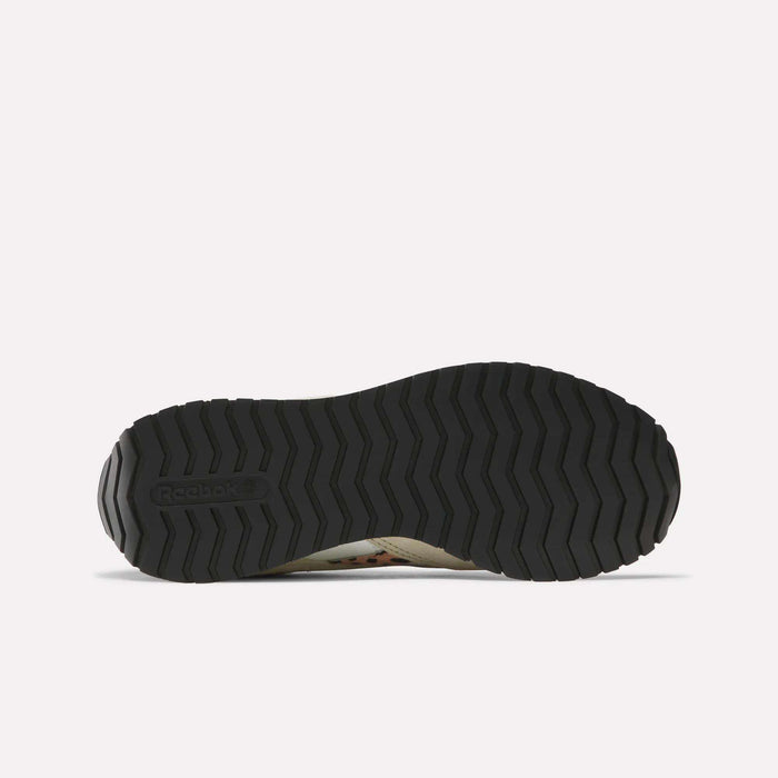 The image displays the black, textured rubber outsole of Reebok Women's Classic AZ Shoes from the bottom on a plain white background, showing a zigzag tread pattern with the Reebok logo on the left side.