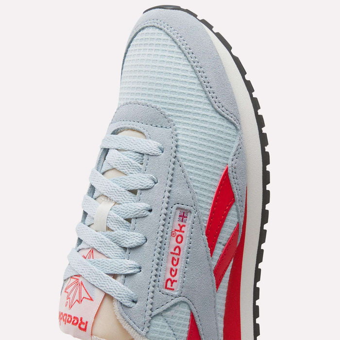 Close-up of a Women's Classic AZ Shoe by Reebok featuring a light blue mesh upper, suede accents, retro-inspired red logo and stripes, white laces, and a black rubber sole.
