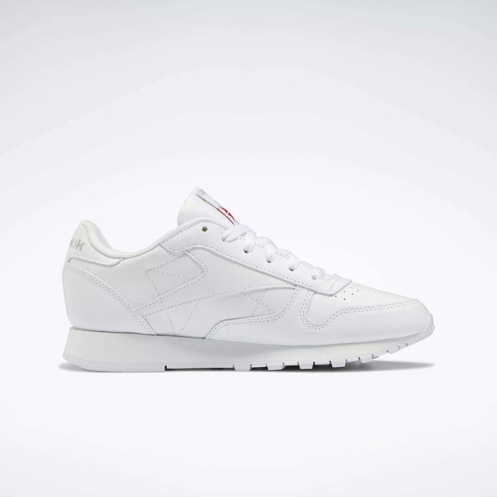 Reebok Women's Classic Leather Shoes feature a low-top design, cushioned midsole, lace-up closure, and subtle side and tongue branding, showcased against a plain white background.
