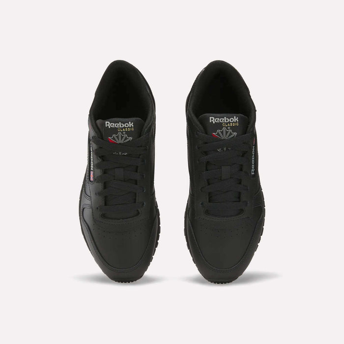 A pair of Reebok Women's Classic Leather Shoes in black, seen from above with visible laces, the Reebok logo on the tongue, side branding, and a cushioned midsole, all displayed on a plain white background.
