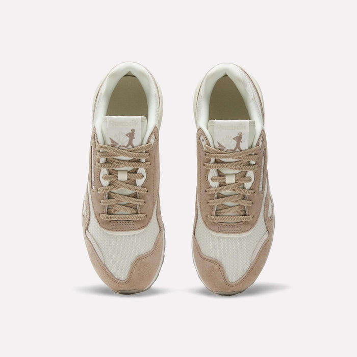 A pair of Women’s Classic Nylon 89 Shoes by Reebok in beige and white, seen from above, display laces, mesh texture, suede overlays, and a retro look with the Reebok logo on each tongue.