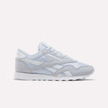 The Reebok Women's Classic Nylon Shoes in Tranquil Blue and White feature a timeless design with a lace-up front, white midsole, and durable rubber outsole—an ideal addition to any women's shoe collection, showcased against a plain white background.
