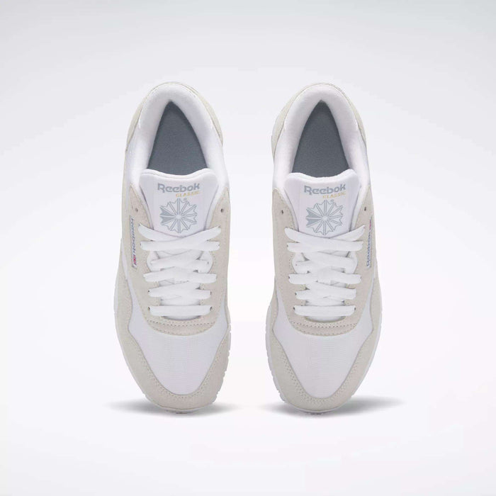 A pair of Women's Classic Nylon Shoes by Reebok, white with light gray accents, is shown from above on a plain background. These sneakers have white laces, a gray insole, and display the Reebok logo on the tongue and side.