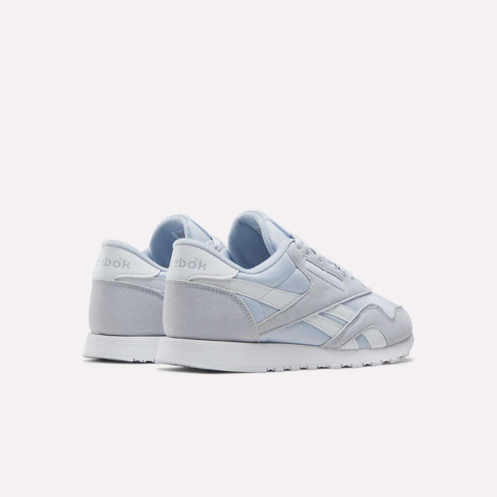A pair of Reebok Women's Classic Nylon Shoes in light gray and white is shown on a plain white background, positioned to display the back and side views of both shoes.