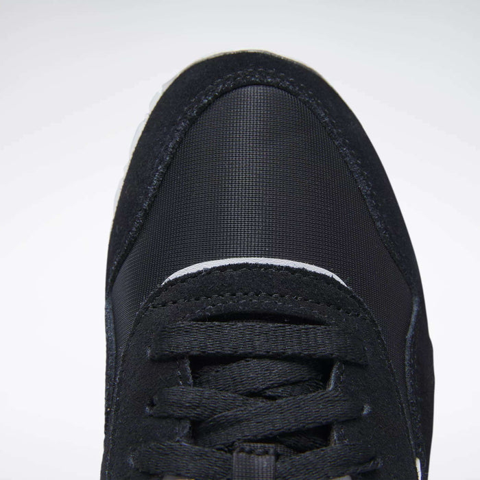 Close-up top view of the front of a black Reebok Women's Classic Nylon Shoe with black laces and a textured, rounded toe cap, shown against a plain white background.