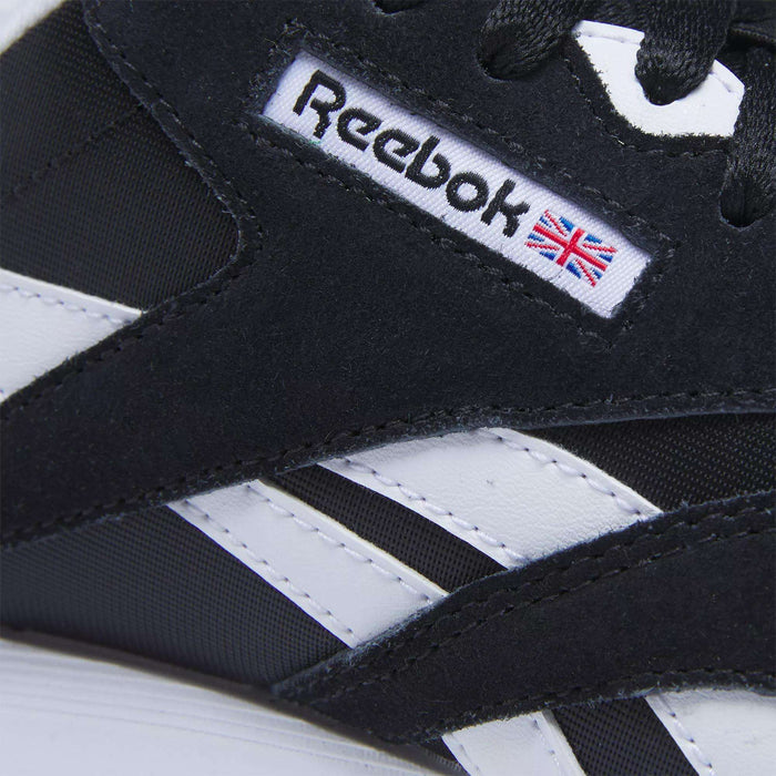 Close-up of Reebok Women's Classic Nylon Shoes in black and white with Reebok logo and Union Jack. The suede and synthetic upper offers style and comfort, making these versatile everyday sneakers ideal for any outfit.