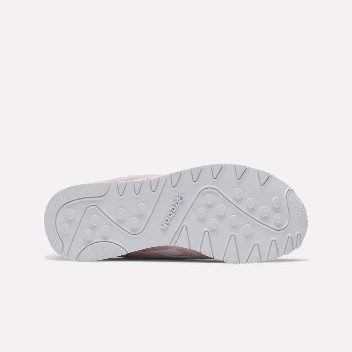 The image features the white rubber outsole of the Reebok Women's Classic Nylon Shoes, displaying a textured pattern with the Reebok logo embossed at the center and showcasing the stylish design from Reebok.