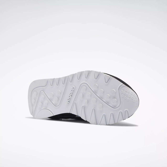 A white sole with textured patterns and raised grips is shown against a plain background, highlighting the Reebok logo—ideal for Women's Classic Nylon Shoes by Reebok and perfect as stylish everyday sneakers.