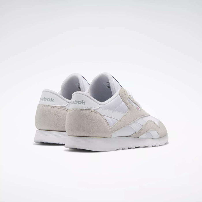 A pair of Women's Classic Nylon Shoes by Reebok in white with light gray accents are displayed at an angle on a plain white background.