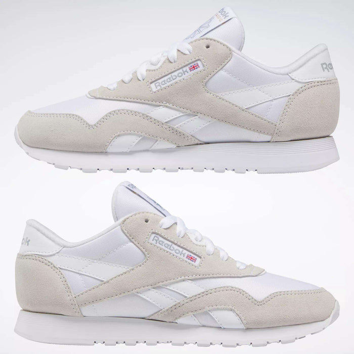 Two white suede Women's Classic Nylon Shoes by Reebok with light gray accents are shown in a side view on a plain background. The Reebok logo and small Union Jack add classic style, making these sneakers perfect for everyday wear.
