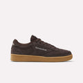 The Women's Club C 85 Shoes by Reebok feature a brown suede upper, visible stitching, gum rubber sole, and Reebok branding on the side and tongue—perfect for adding style to any sneaker collection.