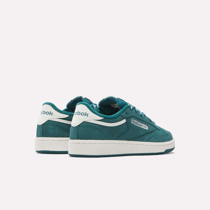 A pair of Reebok Women's Club C 85 Shoes in teal with white soles and accents is shown on a plain white background, one shoe facing forward and the other turned to reveal the back.