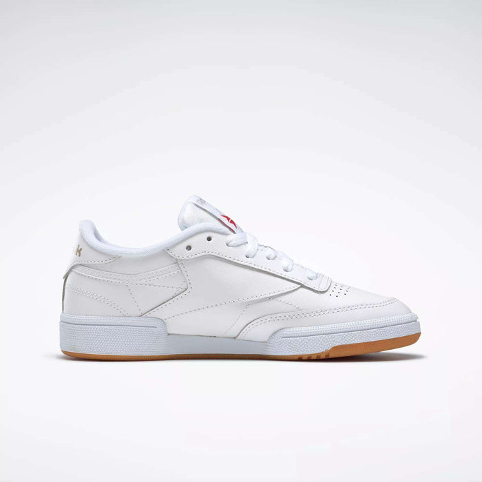 The Reebok Women's Club C 85 Shoes are white low-tops with a gum sole and subtle stitching, shown in side profile against a plain light background.