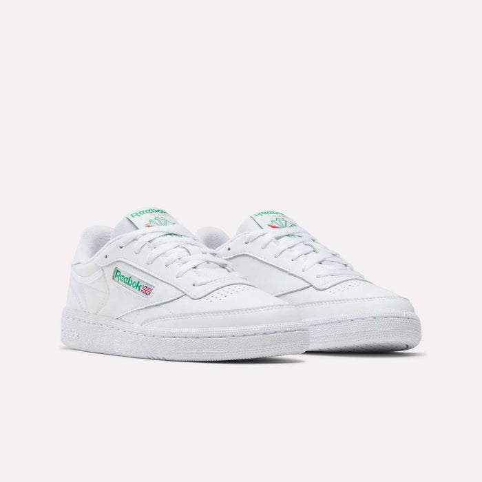 The Reebok Women's Club C 85 Shoes feature a white design with green and red logo accents, white laces, and perforated details, shown against a plain light background.
