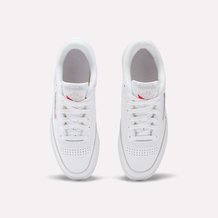 A pair of Reebok Women's Club C 85 Shoes are shown from above on a white background, highlighting their laces, perforated toe area, and the Reebok logo on the tongue.