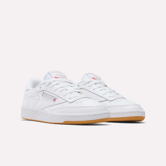 A pair of Reebok Women's Club C 85 Shoes, featuring a classic low-top white design with gum rubber soles and subtle branding, displayed on a plain white background.