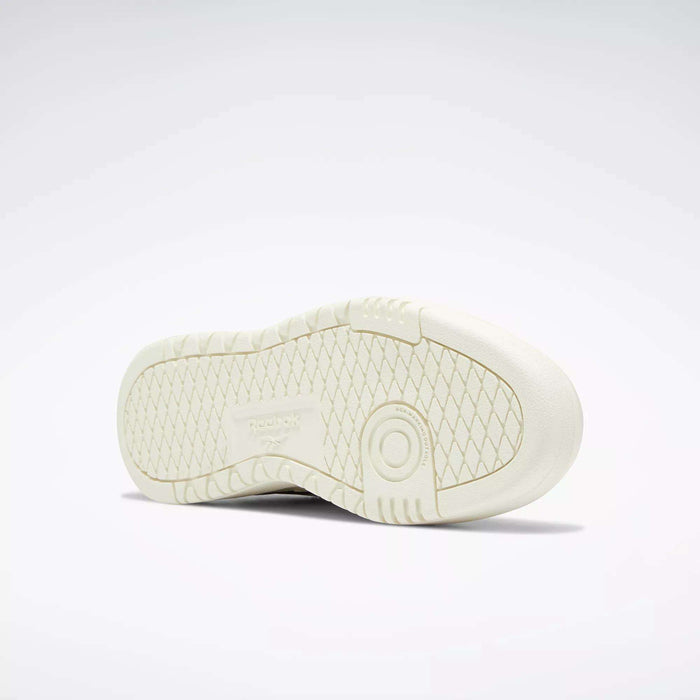 The image displays the sole of a Women's Club C Double Revenge Shoe by Reebok, seen from below. It has a double outsole with a diamond-patterned tread, a circular heel detail, and Reebok branding in the center.
