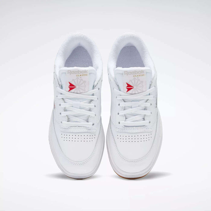 A pair of white Reebok Women's Club C Double Shoes with white laces, seen from above, featuring perforated toe details, a platform midsole, and Reebok branding on the tongue.