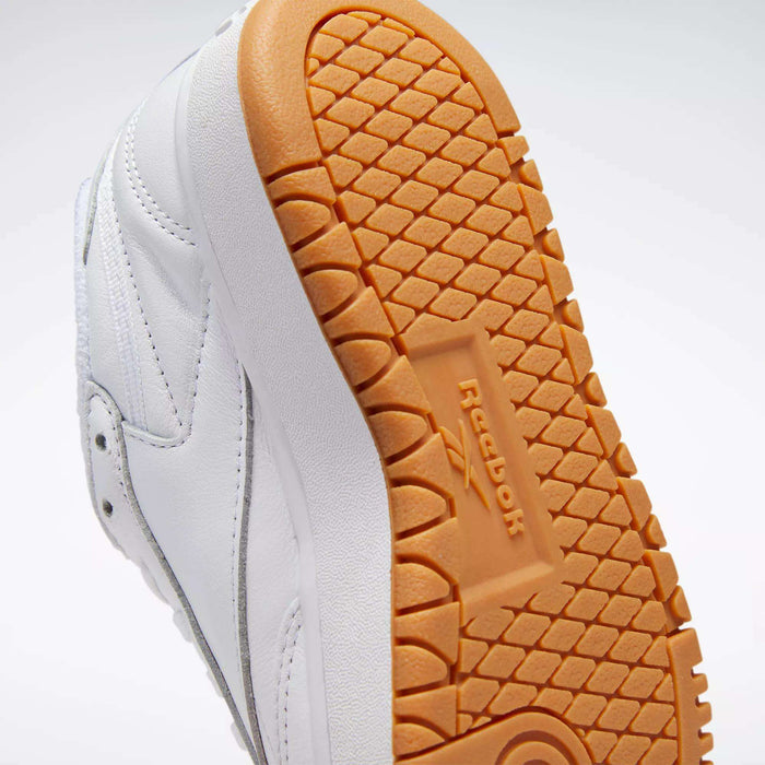Close-up of the sole of Reebok Women's Club C Double Shoes, featuring a textured light brown rubber outsole with the Reebok logo and geometric tread pattern, inspired by classic women's tennis styles.