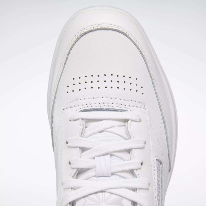 Close-up of the Reebok Women's Club C Double Shoes featuring a white tennis-inspired design, smooth leather upper, toe box, white laces, perforated holes for ventilation, and detailed stitching.