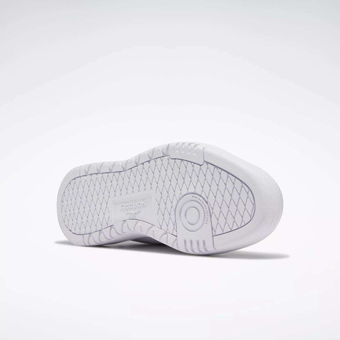 The image displays the white rubber sole of Reebok Women's Club C Double Shoes, showcasing a diamond-patterned tread and a circular detail near the heel, photographed against a plain light background.