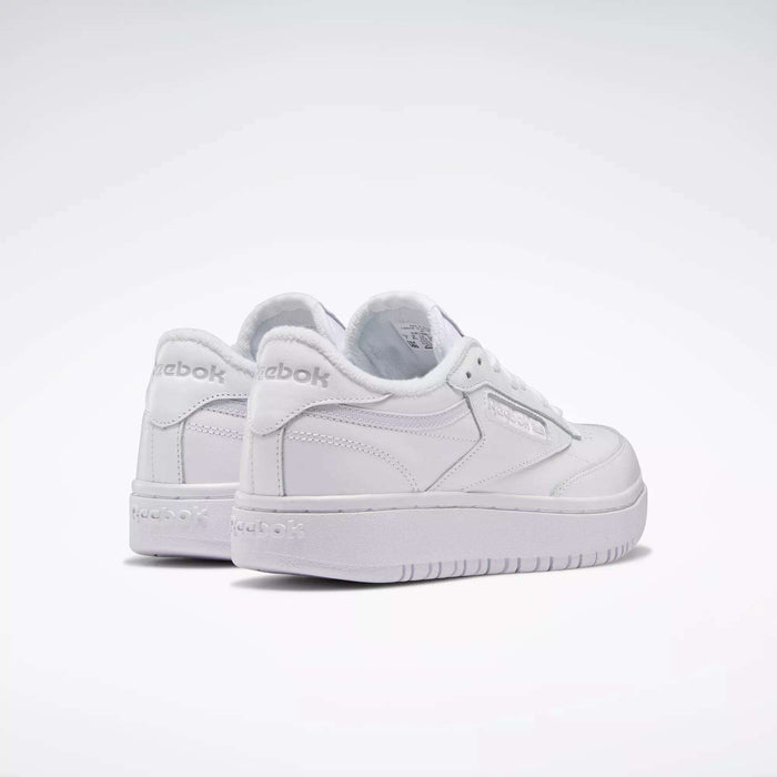 A pair of Reebok Women's Club C Double Shoes in white are displayed on a plain white background, with one shoe slightly ahead of the other, both facing backward.